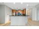 Well-lit kitchen with stainless steel appliances, wood cabinets, breakfast bar and tiled backsplash at 618 N Boylan Ave # 400, Raleigh, NC 27603