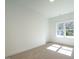 Minimalist bedroom with a neutral carpet, a large window, and a bright atmosphere, making it inviting at 620 Walnut Heights Dr # 103, Raleigh, NC 27610