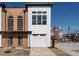 Modern townhome with attached garage and neutral color palette against a clear blue sky at 620 Walnut Heights Dr # 103, Raleigh, NC 27610