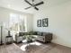 Cozy living area featuring a large window, neutral-toned sectional, and stylish decor, creating a relaxing ambiance at 620 Walnut Heights Dr # 103, Raleigh, NC 27610