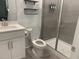Bathroom with a glass door shower and a white vanity with mirror and toilet at 633 Hardin Hill Ln, Knightdale, NC 27545
