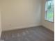 Bedroom with gray carpet, white walls, baseboard and a window at 633 Hardin Hill Ln, Knightdale, NC 27545