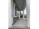 Comfortable front porch boasting stone accents, white columns, and a smooth concrete walkway at 633 Hardin Hill Ln, Knightdale, NC 27545