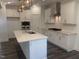 Beautiful kitchen featuring a large island, white cabinetry, stainless steel appliances, and stylish lighting at 633 Hardin Hill Ln, Knightdale, NC 27545