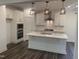 Elegant kitchen showcasing white cabinets, stainless steel appliances, a central island, and modern pendant lights at 633 Hardin Hill Ln, Knightdale, NC 27545