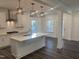 Bright kitchen features white cabinets, subway tile backsplash, stainless steel appliances, and island at 633 Hardin Hill Ln, Knightdale, NC 27545