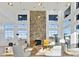 Bright, open living room with soaring ceilings, a stone fireplace, large windows, and elegant decor at 633 Hardin Hill Ln, Knightdale, NC 27545