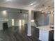 This bright open-concept living area flows from the kitchen and features a fireplace and hardwood floors at 633 Hardin Hill Ln, Knightdale, NC 27545