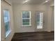 Bright living space with hardwood floors, white trim, windows and exterior door at 633 Hardin Hill Ln, Knightdale, NC 27545
