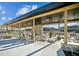 Beautiful outdoor patio area featuring a stone fireplace, ceiling fans, and comfortable seating with views of the community at 633 Hardin Hill Ln, Knightdale, NC 27545