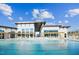 Modern apartment complex featuring a large pool with lounge chairs and pergola with clear blue skies above at 633 Hardin Hill Ln, Knightdale, NC 27545