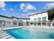 Modern apartment complex featuring a large pool with lounge chairs and pergola with clear blue skies above at 633 Hardin Hill Ln, Knightdale, NC 27545