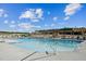 Inviting pool area with clear blue water, lounge chairs, and a covered pavilion under a bright sky at 633 Hardin Hill Ln, Knightdale, NC 27545