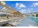 Modern apartment complex featuring a large pool with lounge chairs and pergola with clear blue skies above at 633 Hardin Hill Ln, Knightdale, NC 27545