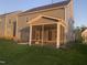 Back view of the house with a screened in back porch and small yard at 633 Hardin Hill Ln, Knightdale, NC 27545