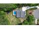 Aerial view of backyard featuring a sparkling pool, deck, and well-maintained landscaping at 66 Romie Ct, Pittsboro, NC 27312