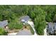 Expansive aerial view of a stately home nestled amidst lush greenery and a circular driveway at 66 Romie Ct, Pittsboro, NC 27312