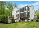 Beautiful, modern home boasts large back windows, a spacious porch and outdoor deck and stairs at 66 Romie Ct, Pittsboro, NC 27312