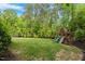 Sprawling backyard has plenty of green space, room for play on the playground and trampoline at 66 Romie Ct, Pittsboro, NC 27312