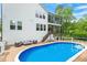 Backyard with a pristine pool, a spacious deck, and comfortable seating, perfect for outdoor relaxation and entertaining at 66 Romie Ct, Pittsboro, NC 27312