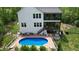 Backyard oasis with a pool, deck, patio seating, and lush landscaping, perfect for outdoor living at 66 Romie Ct, Pittsboro, NC 27312