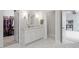 Bright bathroom with white cabinets, gray countertop and marble floor with closet and additional space at 66 Romie Ct, Pittsboro, NC 27312