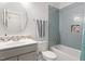 Stylish bathroom with light blue tiling, featuring a shower-tub combination and modern fixtures at 66 Romie Ct, Pittsboro, NC 27312