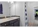 Bathroom featuring modern vanity, tile backsplash, and shower with blue and white curtain at 66 Romie Ct, Pittsboro, NC 27312