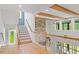 Foyer featuring stairway, hardwood floors and view to the backyard through large windows at 66 Romie Ct, Pittsboro, NC 27312