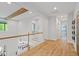 Upstairs hallway with hardwood floors and natural light at 66 Romie Ct, Pittsboro, NC 27312