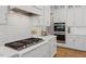 Gourmet kitchen features gas cooktop, quartz counters, and stainless steel appliances for culinary excellence at 66 Romie Ct, Pittsboro, NC 27312