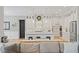 Modern kitchen featuring white cabinetry, a large island, stainless steel appliances, and a stylish eat-in bar at 66 Romie Ct, Pittsboro, NC 27312