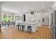 Bright kitchen boasts a spacious island, modern stools, and a connected dining area with natural light at 66 Romie Ct, Pittsboro, NC 27312
