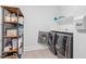 Organized laundry room featuring modern washer and dryer, shelving, and ample storage for laundry essentials at 66 Romie Ct, Pittsboro, NC 27312