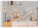 Bright living room with hardwood floors, a staircase and an inviting atmosphere for relaxation and socializing at 66 Romie Ct, Pittsboro, NC 27312
