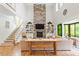 Spacious living room with a stunning stone fireplace and built-in bookshelves at 66 Romie Ct, Pittsboro, NC 27312