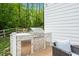 Built-in outdoor kitchen with a grill, counter space, and storage, ideal for backyard cooking and entertaining at 66 Romie Ct, Pittsboro, NC 27312