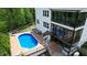 Backyard pool with deck, lounge chairs, and screened-in porch perfect for relaxation and entertainment at 66 Romie Ct, Pittsboro, NC 27312
