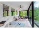 Tranquil sunroom featuring panoramic views, exercise equipment, and plenty of natural light at 66 Romie Ct, Pittsboro, NC 27312