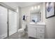 Stylish bathroom featuring glass enclosed shower, tiled floors and a white vanity at 70 Saintsbury Dr, Fuquay Varina, NC 27526