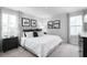 Modern bedroom with neutral colored walls, carpet and large windows with patterned curtains at 70 Saintsbury Dr, Fuquay Varina, NC 27526