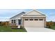 Charming one-story home with a two-car garage and well-maintained lawn on a sunny day at 70 Saintsbury Dr, Fuquay Varina, NC 27526