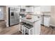 Modern kitchen with stainless steel appliances, granite countertops and an island with seating at 70 Saintsbury Dr, Fuquay Varina, NC 27526