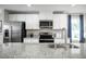 Modern kitchen featuring stainless steel appliances, granite countertops, and a stylish stainless sink at 70 Saintsbury Dr, Fuquay Varina, NC 27526