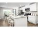 Bright kitchen featuring white cabinets, stainless steel appliances, granite countertops and eat-in island at 70 Saintsbury Dr, Fuquay Varina, NC 27526