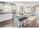 Open-concept kitchen and living room with hardwood floors and plenty of natural light at 70 Saintsbury Dr, Fuquay Varina, NC 27526