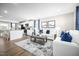 Open concept living room featuring an eat-in kitchen, hardwood flooring, and modern neutral decor at 70 Saintsbury Dr, Fuquay Varina, NC 27526
