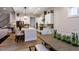 Well-lit kitchen with white cabinets, island, stainless steel appliances, and hardwood floors, open to dining area at Tbd Hudson Hills Rd, Pittsboro, NC 27312