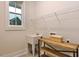 Functional laundry room with utility sink, wooden shelving, a window, and ample space for storage at Tbd Hudson Hills Rd, Pittsboro, NC 27312