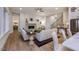 Bright living room with hardwood floors, fireplace, and comfortable seating, open to kitchen and dining area at Tbd Hudson Hills Rd, Pittsboro, NC 27312